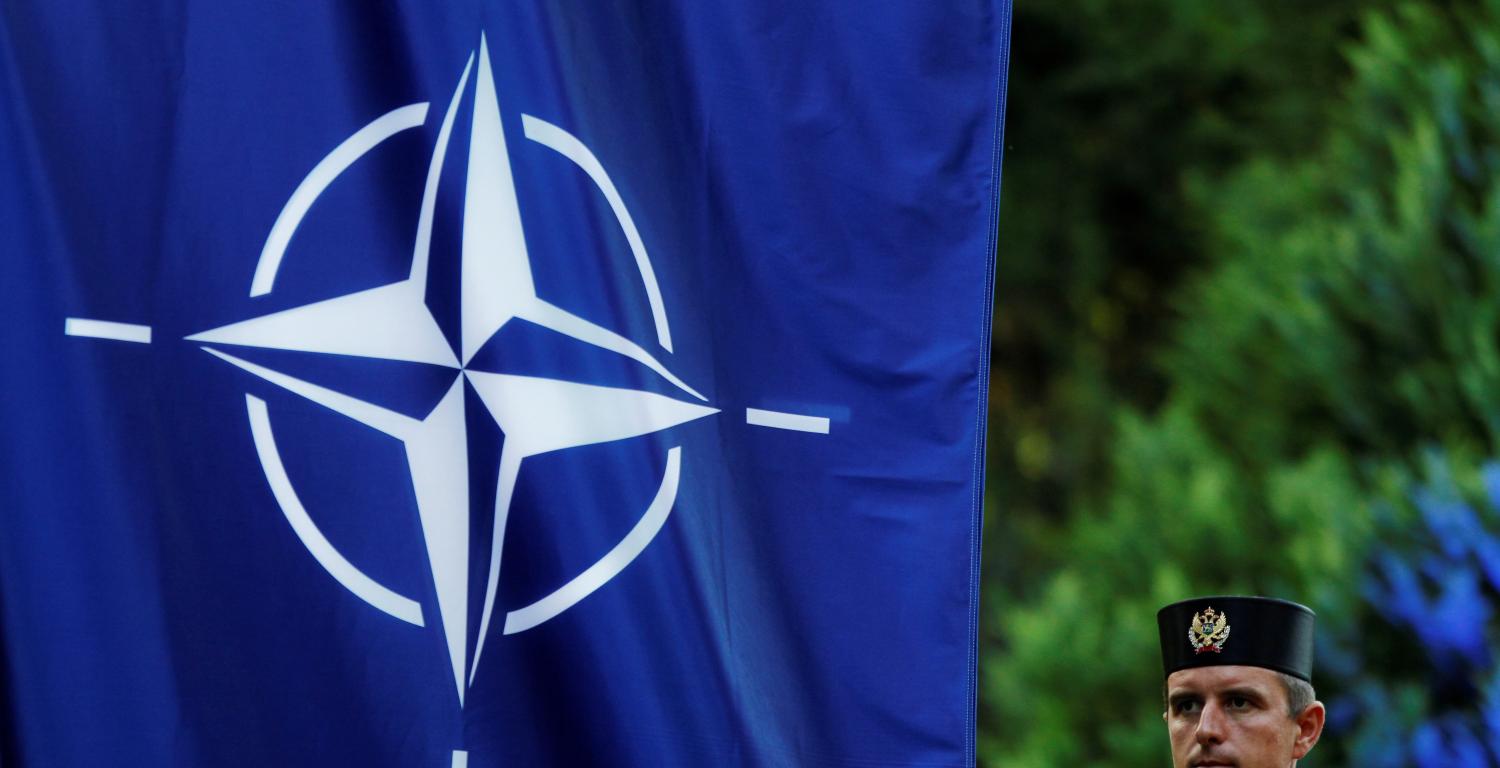 A Montenegrin guard of honor stands next to NATO flag during a ceremony to mark the accession to NATO of Montenegro in Podgorica, Montenegro, June 7, 2017. REUTERS/Stevo Vasiljevic - RTX39IGM