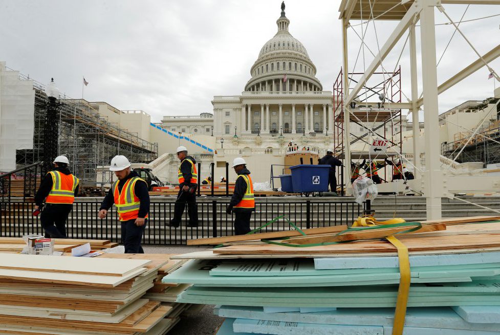 Workers construct the viewing stands ahead of U.S. President-elect Donald Trump's January inauguration at the U.S. Capitol in Washington, U.S., December 8, 2016. REUTERS/Jonathan Ernst - RTSVA7V