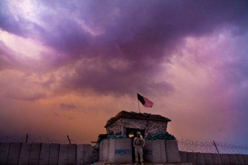 A U.S. Marine from the First Battalion Eighth Marines Alpha Company looks out as an evening storm gathers above an outpost near Kunjak in southern Afghanistan's Helmand province, February 22, 2011. REUTERS/Finbarr O'Reilly/File Photo TPX IMAGES OF THE DAY - RTX2K2IW