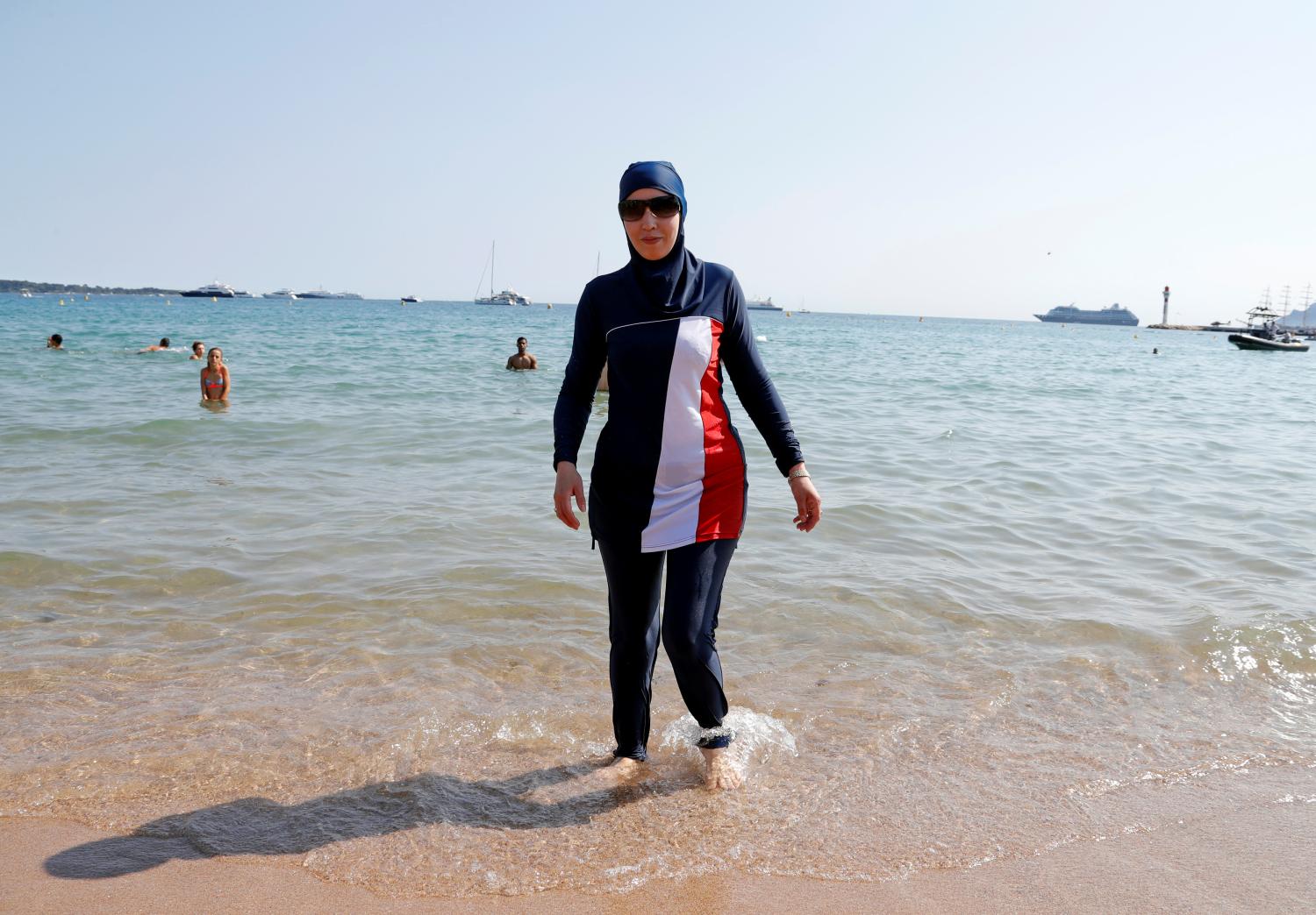 70th Cannes Film Festival - Cannes, France. 27/05/2017. Karima, wearing a full-body burkini swimsuit, walks on a beach in Cannes after the call to support the wearing of burkinis by businessman and political activist Rachid Nekkaz. REUTERS/Eric Gaillard