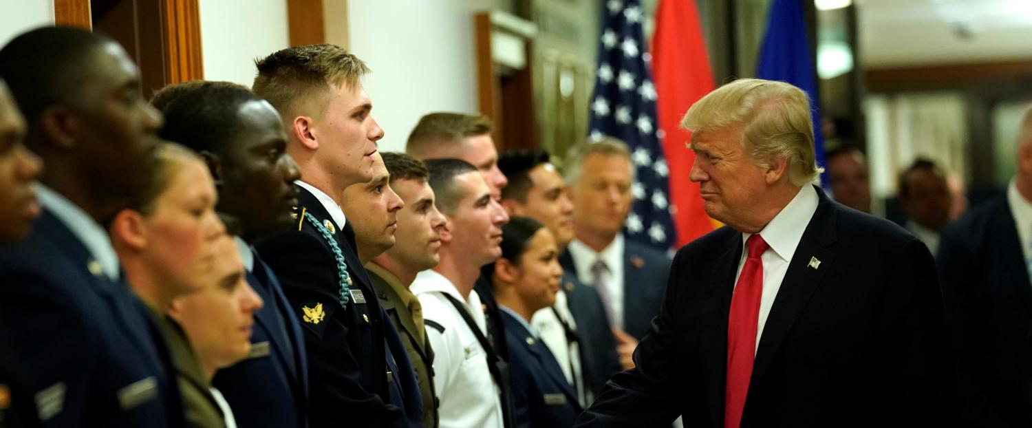 U.S. President Donald Trump greets military personnel