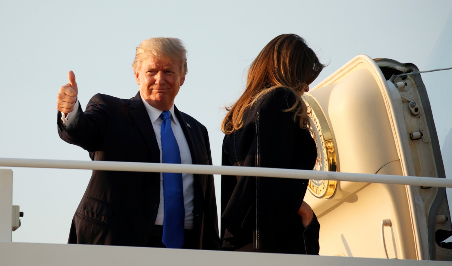 U.S. President Donald Trump gives a thumbs up as he and first lady Melania Trump board Air Force One as they depart Joint Base Andrews in Maryland, U.S., July 12, 2017. REUTERS/Kevin Lamarque TPX IMAGES OF THE DAY - RTX3B7RA