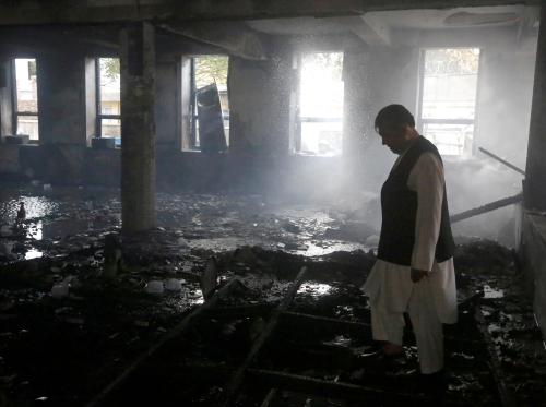 An Afghan man inspects the site of a suicide attack followed by a clash between Afghan forces and insurgents after an attack on a Shi'ite Muslim mosque in Kabul, Afghanistan, August 25, 2017. REUTERS/Omar Sobhani TPX IMAGES OF THE DAY - RTS1DATN