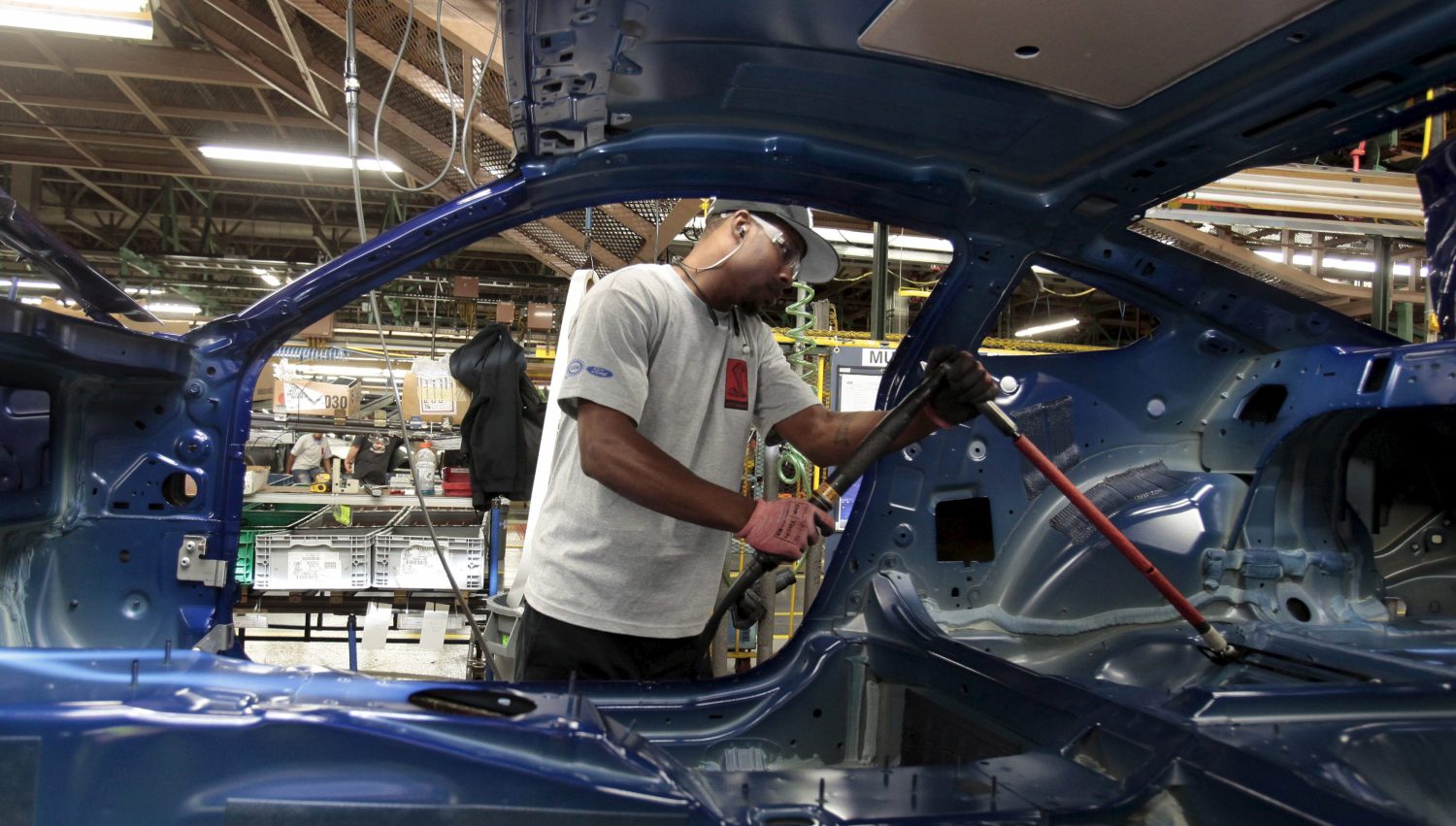 A Ford Motor assembly worker works on the frame of a 2015 Ford Mustang vehicle at the Ford Motor Flat Rock Assembly Plant in Flat Rock, Michigan, August 20, 2015. REUTERS/Rebecca Cook - RTX1OYPW