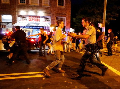 Police and sheriffs fight with protesters trying to free their arrested colleague after a demonstration turned violent during a protest against a statue of a Confederate solider nicknamed Silent Sam on the campus of the University of North Carolina in Chapel Hill, North Carolina, U.S. August 22, 2017. REUTERS/Jonathan Drake