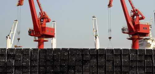 Piles of steel pipes to be exported are seen in front of cranes at a port in Lianyungang, Jiangsu province March 7, 2015. China's exports jumped 48.3 percent in February from a year earlier, while imports fell 20.5 percent, producing a trade deficit of $60.6 billion for the month, the General Administration of Customs said on Sunday. Picture taken March 7, 2015. REUTERS/Stringer (CHINA - Tags: BUSINESS POLITICS) CHINA OUT. NO COMMERCIAL OR EDITORIAL SALES IN CHINA - RTR4SGWY