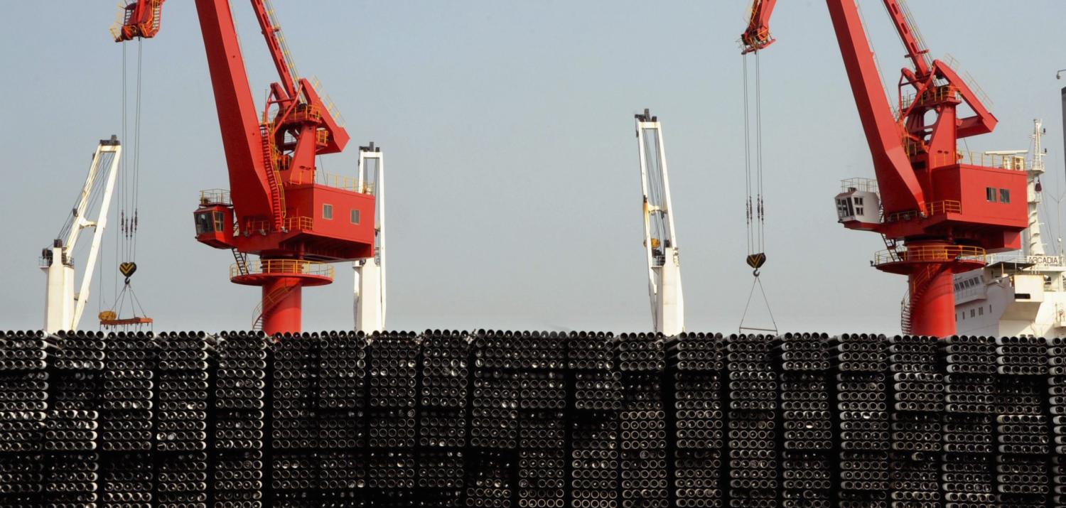 Piles of steel pipes to be exported are seen in front of cranes at a port in Lianyungang, Jiangsu province March 7, 2015. China's exports jumped 48.3 percent in February from a year earlier, while imports fell 20.5 percent, producing a trade deficit of $60.6 billion for the month, the General Administration of Customs said on Sunday. Picture taken March 7, 2015. REUTERS/Stringer (CHINA - Tags: BUSINESS POLITICS) CHINA OUT. NO COMMERCIAL OR EDITORIAL SALES IN CHINA - RTR4SGWY