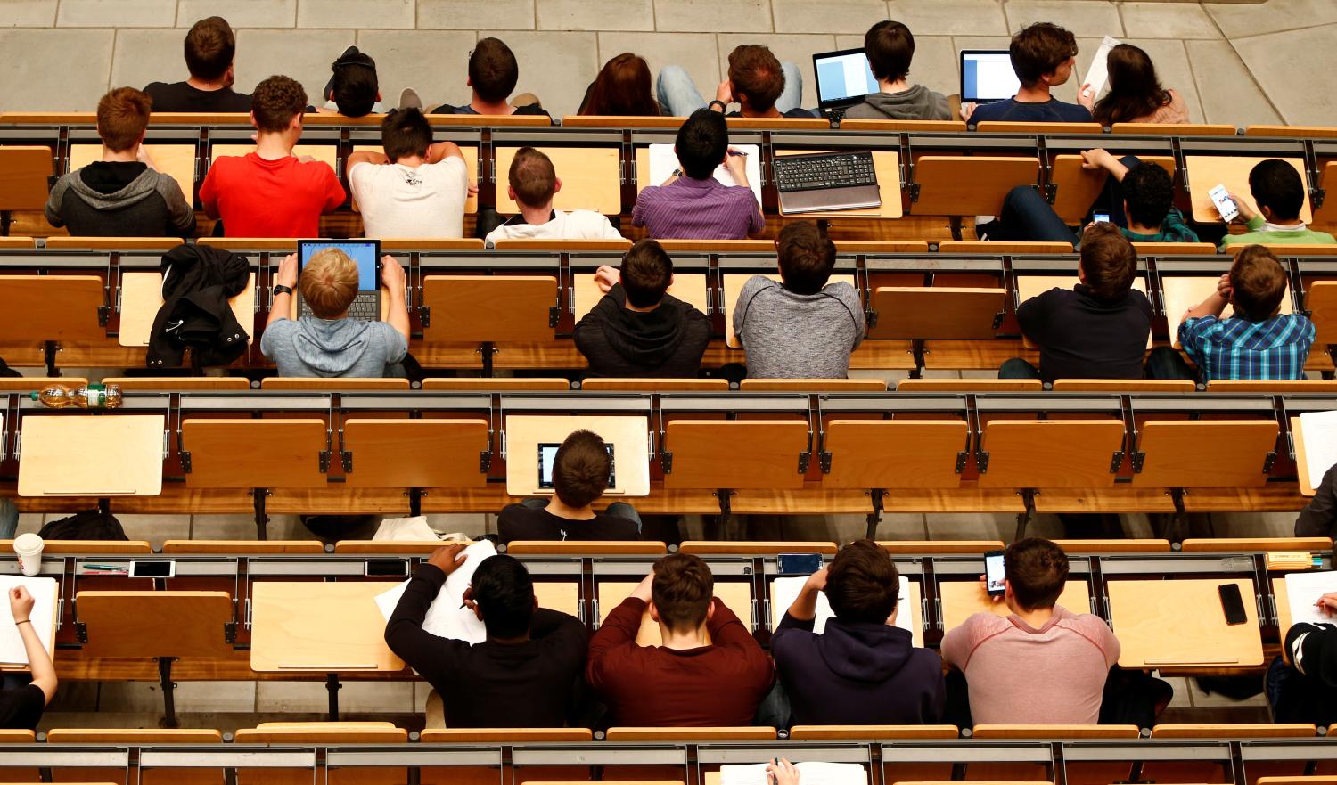 Students attend a lecture in the auditorium of the university.