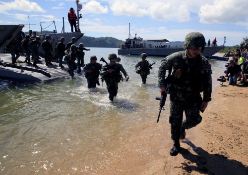 Filipino soldiers disembark from the landing ship before they dock at Motiong Beach during the Humanitarian Assistance and Disaster Response scenario during the Philippines and United States annual Balikatan (Shoulder-to-Shoulder) exercises