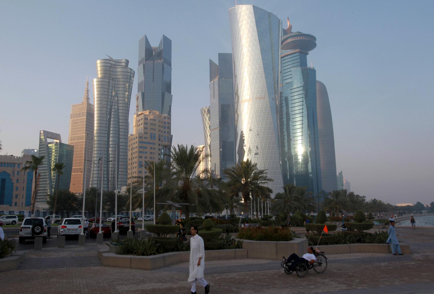 A man walks on the corniche in Doha, Qatar,