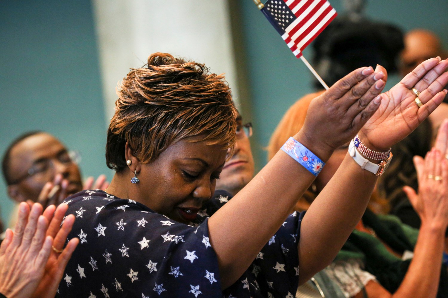 A new U.S. citizen reacts to calls for diversity inclusion by a speaker during an Independence Day naturalization ceremony held by U.S. Citizenship and Immigration Services for 503 people at Seattle Center in Seattle, Washington July 4, 2016. REUTERS/David Ryder