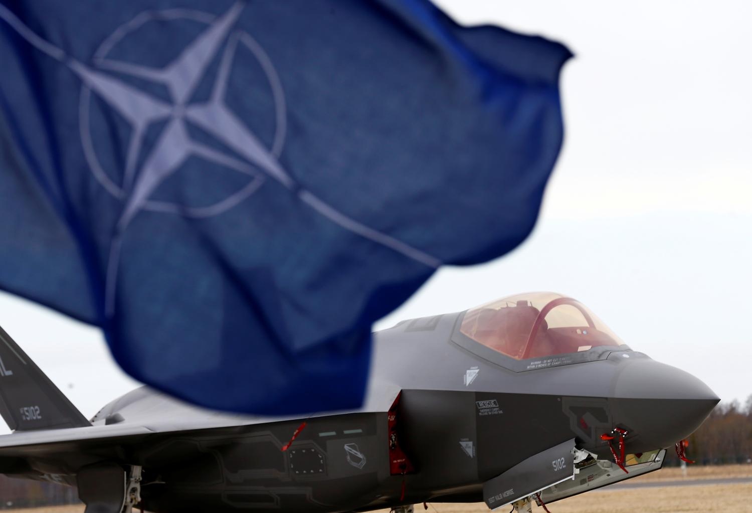 NATO flag flutters next to the U.S. Air Force F-35A Lightning II fighter in Amari air base, Estonia, April 25, 2017. REUTERS/Ints Kalnins - RTS13UDN
