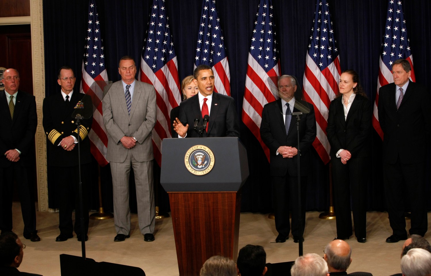 U.S. President Barack Obama (front) delivers remarks in Washington announcing a comprehensive, new strategy for Afghanistan and Pakistan March 27, 2009. Standing behind Obama (L-R) are advisor Bruce Riedel, Commander of the Joint Chiefs of Staff Mike Mullen, National Security Advisor James Jones, Secretary of State Hillary Clinton, Secretary of Defense Robert Gates, Under Secretary of Defense for Policy Michele Flournoy and Special Envoy to Afghanistan Richard Holbrooke. REUTERS/Kevin Lamarque (UNITED STATES POLITICS) - RTXDA7R