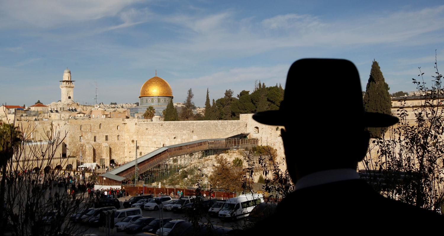 An ultra-Orthodox Jewish man stands at a view-point overlooking a wooden ramp (C) leading up from Judaism's Western Wall to the sacred compound known to Muslims as the Noble Sanctuary and to Jews as Temple Mount, where the al-Aqsa mosque and the Dome of the Rock shrine stand, in Jerusalem's Old City December 12, 2011. REUTERS/Ronen Zvulun/File Photo - RTSS5BJ