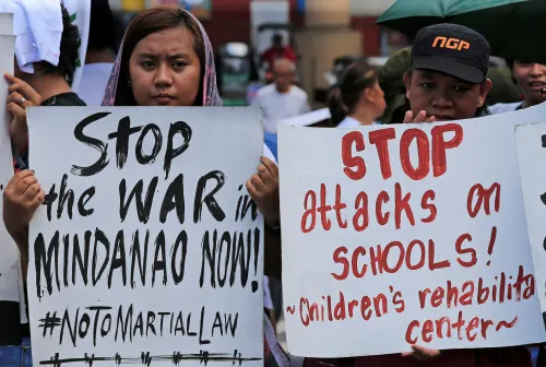 DATE IMPORTED:June 30, 2017Activists hold placards calling for peace in war-torn Marawi as they join other protesters on President Rodrigo Duterte's first year in office during a rally outside the presidential palace in Metro Manila, Philippines June 30, 2017. REUTERS/Romeo Ranoco