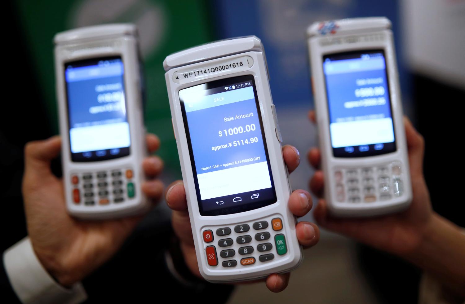 People pose with high security digital payment units