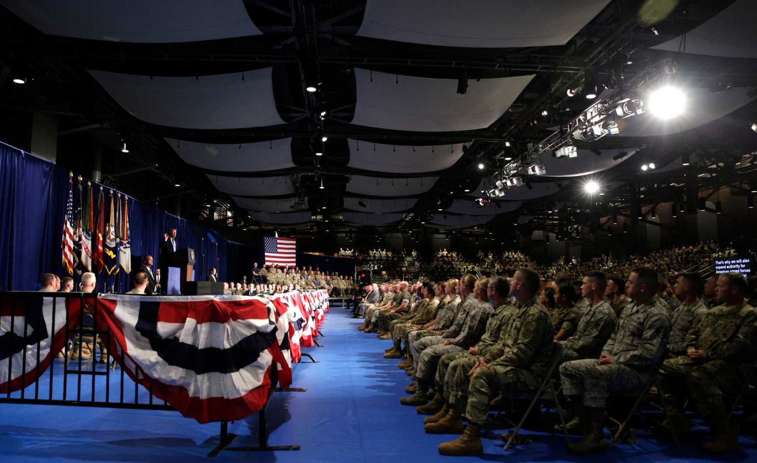 Military personnel watch as U.S. President Donald Trump (L) announces his strategy for the war in Afghanistan during an address to the nation from Fort Myer, Virginia, U.S., August 21, 2017. REUTERS/Joshua Roberts - RTS1CQS1
