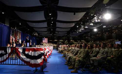 Military personnel watch as U.S. President Donald Trump (L) announces his strategy for the war in Afghanistan during an address to the nation from Fort Myer, Virginia, U.S., August 21, 2017. REUTERS/Joshua Roberts - RTS1CQS1