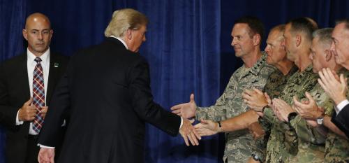 U.S. President Donald Trump shakes hands with military officers as he departs after announcing his strategy for the war in Afghanistan during an address to the nation from Fort Myer, Virginia, U.S., August 21, 2017. REUTERS/Joshua Roberts - RTS1CQRT