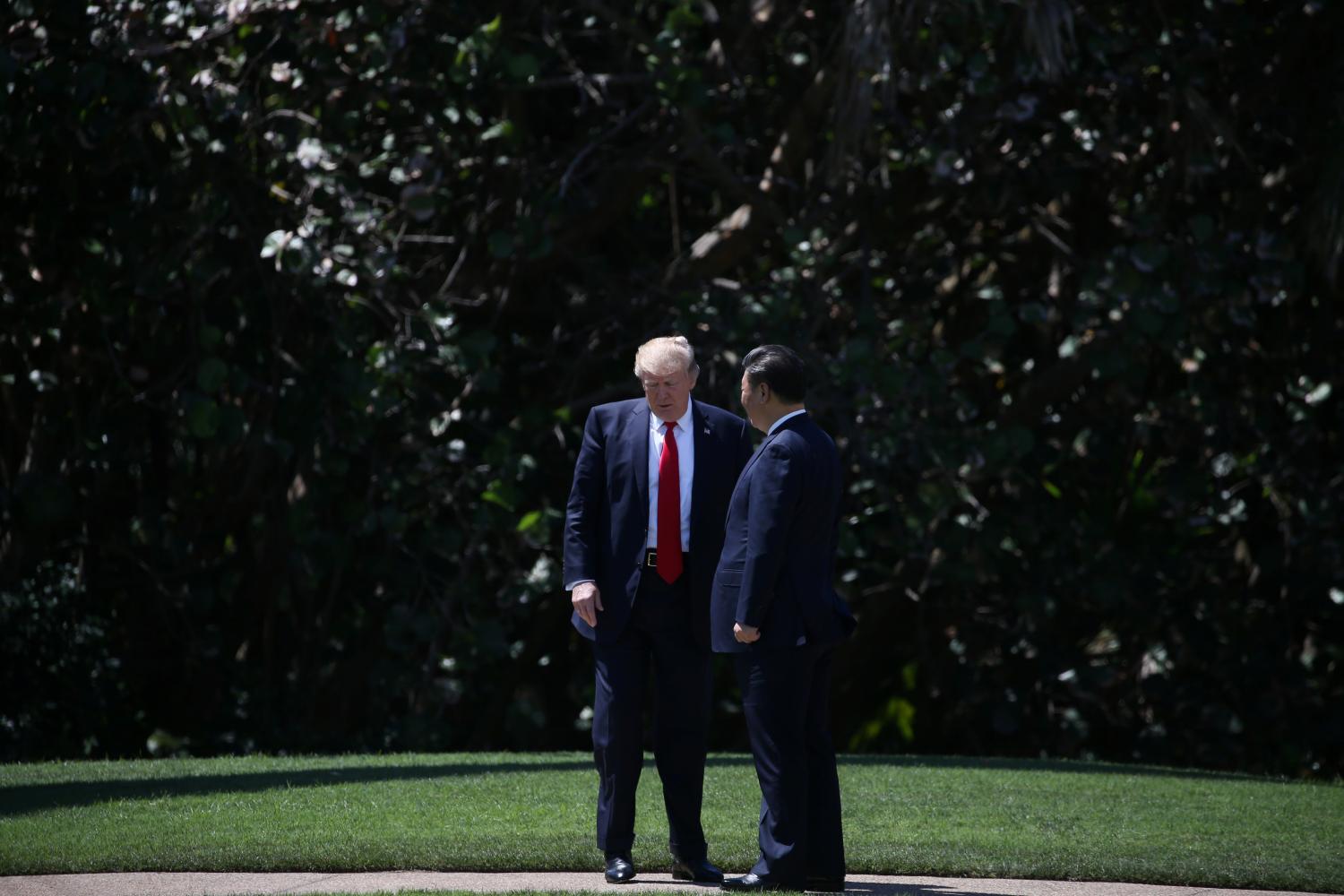 U.S. President Donald Trump and China's President Xi Jinping chat as they walk along the front patio of the Mar-a-Lago estate after a bilateral meeting in Palm Beach, Florida, U.S., April 7, 2017. REUTERS/Carlos Barria - RTX34MA2