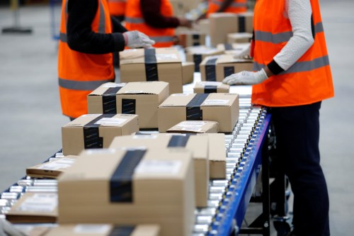 Employees sort packages at the Amazon distribution center