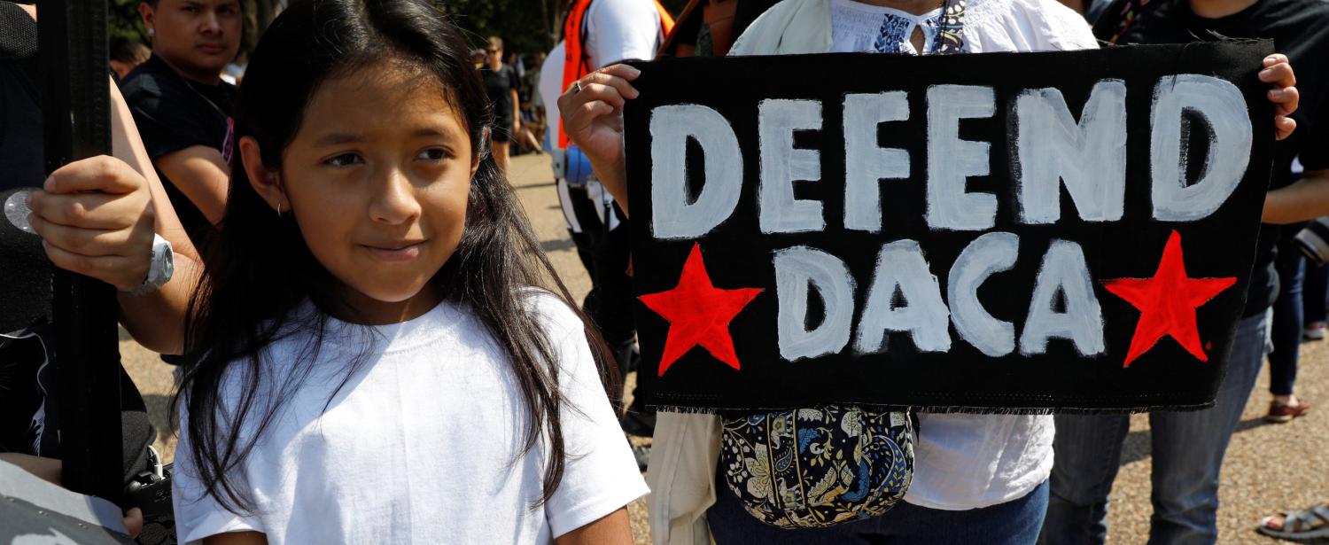 Demonstrators hold signs during a protest in front of the White House after the Trump administration today scrapped the Deferred Action for Childhood Arrivals (DACA), a program that protects from deportation almost 800,000 young men and women who were brought into the U.S. illegally as children, in Washington, U.S., September 5, 2017. REUTERS/Kevin Lamarque - RC12174D8090