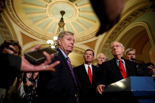 Senate Majority Leader Mitch McConnell, accompanied by Sen. Lindsey Graham (R-SC), Sen. John Barrasso (R-WY), Sen. John Cornyn (R-TX) and Sen. Bill Cassidy (R-LA), speaks with reporters following the party luncheons on Capitol Hill.
