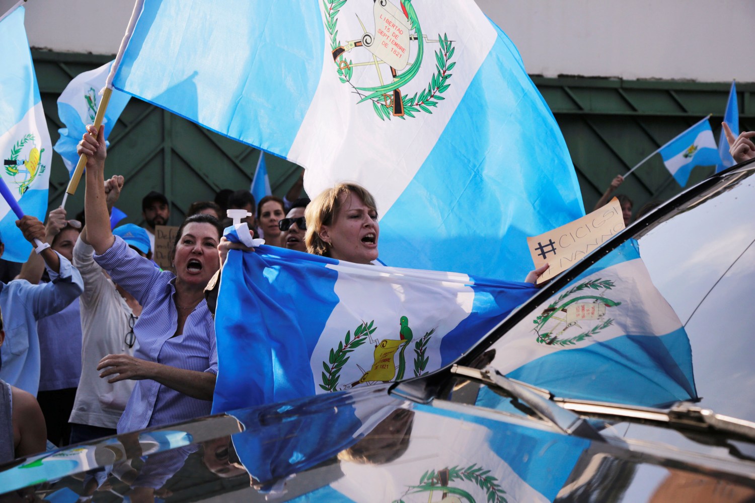 A demonstrator reacts against a car leaving from the Guatemalas's International Commission Against Impunity (CICIG) headquarters as she protests in support of Guatemalan President Jimmy Morales and his decision to expel Ivan Velasquez, head of CICIG, outside the CICIG headquarters in Guatemala City, Guatemala, August 27, 2017. REUTERS/Luis Echeverria - RC16CC075790