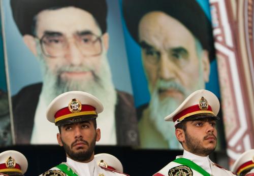 Soldiers stand guard under the pictures of Ayatollah Ruhollah Khomeini, the founder of the Islamic Republic (R), and Iran's Supreme Leader Ayatollah Ali Khamenei during the anniversary ceremony of Iran's Islamic Revolution at the Khomeini shrine in the Behesht Zahra cemetery, south of Tehran, February 1, 2011.