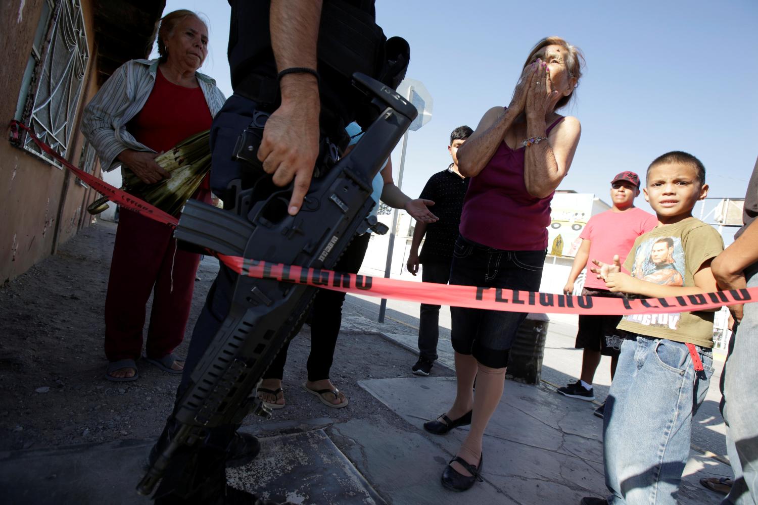 The relative of a teenager gunned down by unknown assailants reacts at a crime scene in Ciudad Juarez, Mexico, June 30, 2017. REUTERS/Jose Luis Gonzalez - RC11ADC26E60