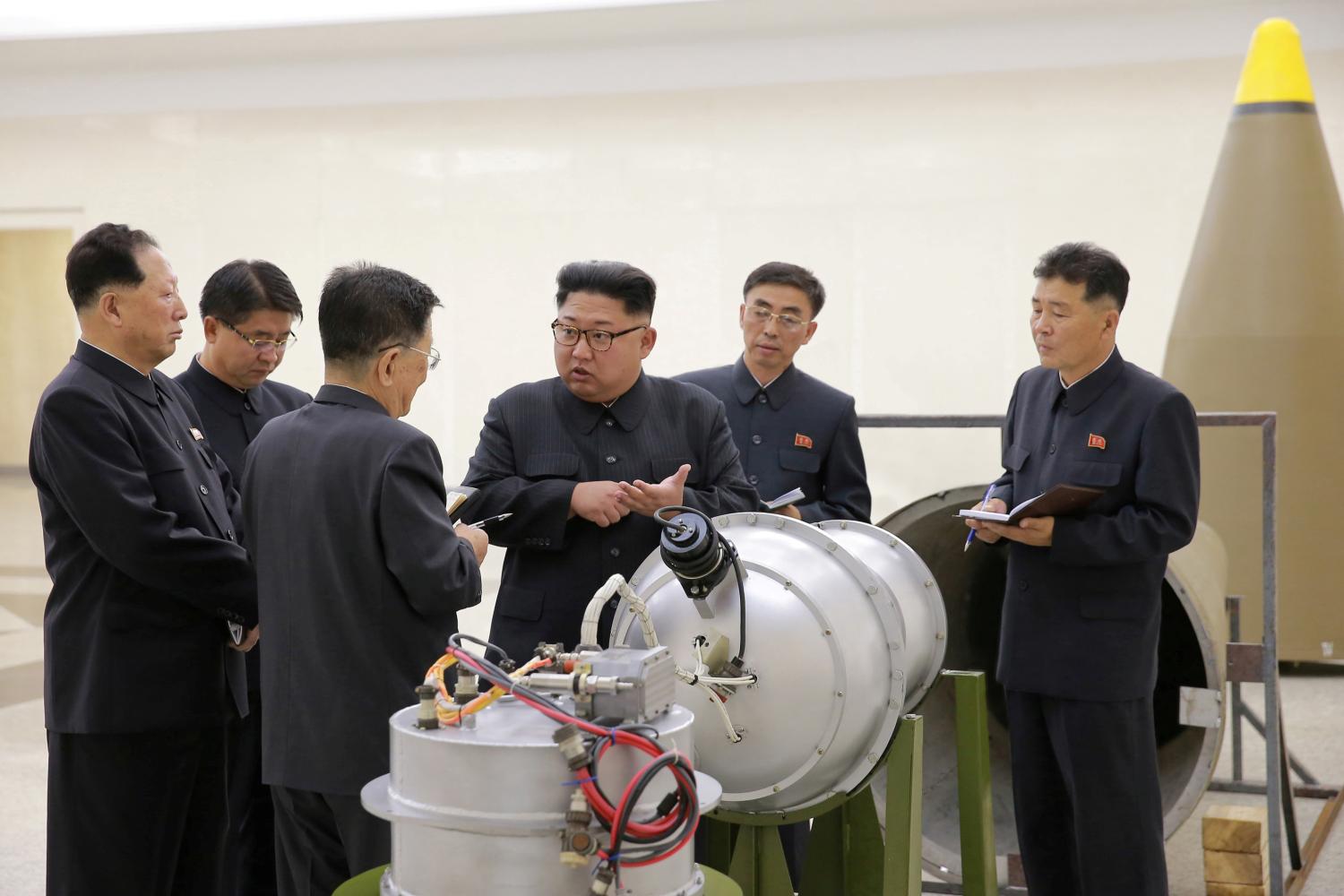 North Korean leader Kim Jong Un provides guidance with Ri Hong Sop (3rd L) and Hong Sung Mu (L) on a nuclear weapons program in this undated photo released by North Korea's Korean Central News Agency (KCNA) in Pyongyang September 3, 2017. KCNA via REUTERS ATTENTION EDITORS - THIS PICTURE WAS PROVIDED BY A THIRD PARTY. REUTERS IS UNABLE TO INDEPENDENTLY VERIFY THE AUTHENTICITY, CONTENT, LOCATION OR DATE OF THIS IMAGE. NOT FOR SALE FOR MARKETING OR ADVERTISING CAMPAIGNS. NO THIRD PARTY SALES. NOT FOR USE BY REUTERS THIRD PARTY DISTRIBUTORS. SOUTH KOREA OUT. NO COMMERCIAL OR EDITORIAL SALES IN SOUTH KOREA. THIS PICTURE IS DISTRIBUTED EXACTLY AS RECEIVED BY REUTERS, AS A SERVICE TO CLIENTS.