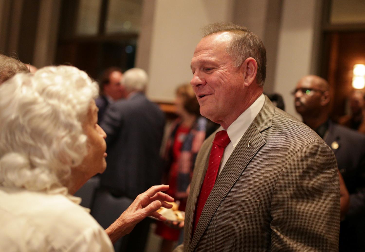 Republican candidate Roy Moore greets supporters during the runoff election for the Republican nomination for Alabama's U.S. Senate seat vacated by Attorney General Jeff Sessions, at the RSA Activity center in Montgomery, Alabama, U.S. September 26, 2017. REUTERS/Marvin Gentry - RC14EDB4C0C0