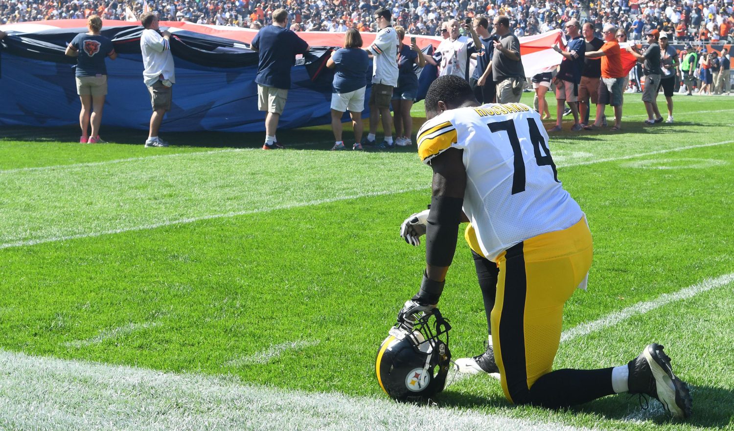 NFL player kneeling.