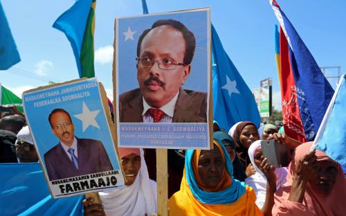 Women carry posters with the image of the newly elected Somalian President Mohamed Abdullahi Mohamed as they celebrate his victory, near the Daljirka Dahson monument in Mogadishu, Somalia February 11, 2017. REUTERS/Feisal Omar - RC1BD325F8B0