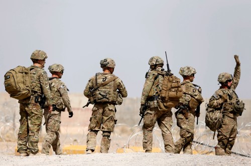 U.S. troops walk outside their base in Uruzgan province, Afghanistan July 7, 2017. REUTERS/Omar Sobhani TPX IMAGES OF THE DAY - RC1A81864000