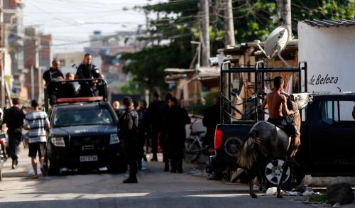 DATE IMPORTED:March 30, 2014A boy rides his horse as policemen of Special Operations Battalion (BOPE) patrol at the Mare slums complex in Rio de Janeiro, March 30, 2014.The Federal troops and police occupied the Mare slums complex on Sunday to help quell a surge in violent crime following attacks by drug traffickers on police posts in three slums on the north side of the city, government officials said. Less than three months before Rio welcomes tens of thousands of foreign soccer fans for the World Cup, the attacks cast new doubts on government efforts to expel gangs from slums using a strong police presence. The city will host the Olympics in 2016. REUTERS/Sergio Moraes (BRAZIL - Tags: CRIME LAW SPORT SOCCER)