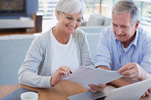 Image: A senior couple working on their finances using a laptop.