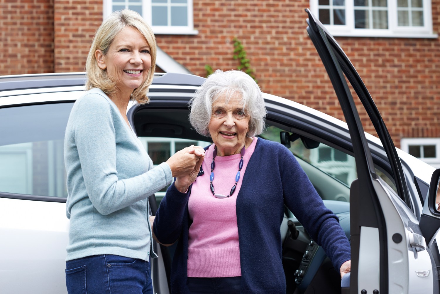 Female Neighbor Giving Senior Woman A Lift In Car. iStock/Highwaystarz-Photography