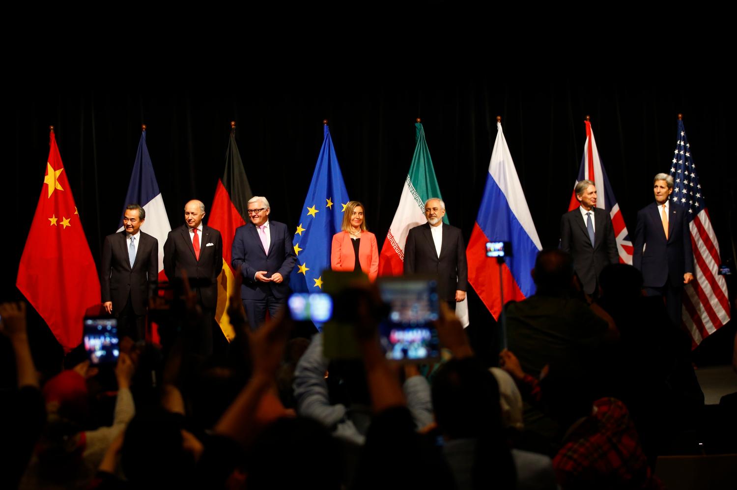 Chinese Foreign Minister Wang Yi, French Foreign Minister Laurent Fabius, German Foreign Minister Frank Walter Steinmeier, High Representative of the European Union for Foreign Affairs and Security Policy Federica Mogherini, Iranian Foreign Minister Mohammad Javad Zarif, British Foreign Secretary Philip Hammond and U.S. Secretary of State John Kerry (L-R) pose for a family picture after the last plenary session at the United Nations building in Vienna, Austria July 14, 2015. Iran and six major world powers reached a nuclear deal on Tuesday, capping more than a decade of on-off negotiations with an agreement that could potentially transform the Middle East, and which Israel called an "historic surrender". REUTERS/Leonhard Foeger - LR2EB7E0WT005