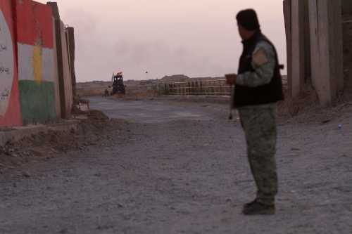 A Kurdish Peshmerga fighter looks at the Shi'ite Popular Mobilization Forces (PMF) in the Southwest of Kirkuk, Iraq October 13, 2017.