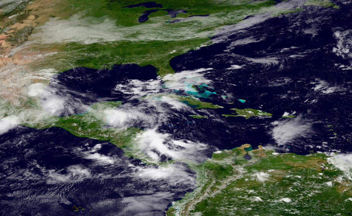 Mexico, Central America and the Caribbean region are pictured in this September 16, 2013 NASA satellite handout photo, which shows the remains of Tropical Storm Ingrid on the east coast of Mexico. Ingrid and the remnants of what was once Tropical Storm Manuel, on the west coast, inundated most of Mexico from both coasts, causing deadly flooding that killed 22 people. REUTERS/NASA/Handout via Reuters (UNITED STATES - Tags: DISASTER ENVIRONMENT) THIS IMAGE HAS BEEN SUPPLIED BY A THIRD PARTY. IT IS DISTRIBUTED, EXACTLY AS RECEIVED BY REUTERS, AS A SERVICE TO CLIENTS. FOR EDITORIAL USE ONLY. NOT FOR SALE FOR MARKETING OR ADVERTISING CAMPAIGNS - GM1E99H096Y01