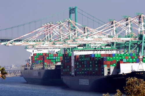 Freighters and cargo containers sit idle at the Port of Los Angeles as a back-log of over 30 container ships sit anchored outside the Port in Los Angeles, California, February 18, 2015. U.S. Labor Secretary Tom Perez planned to hold a second round of talks with shipping company executives and union leaders for 20,000 dock workers on Wednesday, seeking to broker a deal to end months of labor turmoil clogging cargo traffic at 29 West Coast ports. REUTERS/Bob Riha, Jr. (UNITED STATES - Tags: TRANSPORT BUSINESS EMPLOYMENT) - TM3EB2I1BQA01