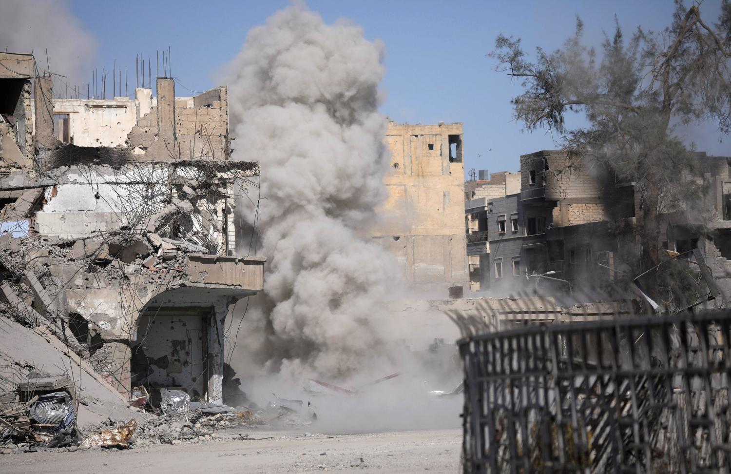 Smoke rises after a landmine exploded as fighters of Syrian Democratic Forces are clearing roads after liberation of Raqqa, Syria October 18, 2017. REUTERS/Rodi Said - RC1CA83C2BB0