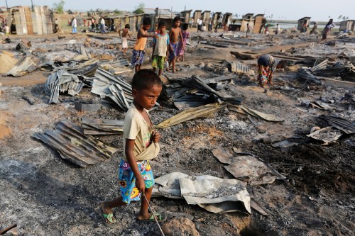 A boy walks among debris after fire destroyed shelters at a camp for internally displaced Rohingya Muslims in the western Rakhine State near Sittwe, Myanmar May 3, 2016. REUTERS/Soe Zeya Tun TPX IMAGES OF THE DAY