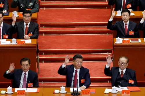 (L to R) Former Chinese president Hu Jintao, Chinese President Xi Jinping and former Chinese president Jiang Zemin raise their hands as they take a vote at the closing session of the 19th National Congress of the Communist Party of China, in Beijing, China October 24, 2017. REUTERS/Thomas Peter TPX IMAGES OF THE DAY - RC186FB9D730