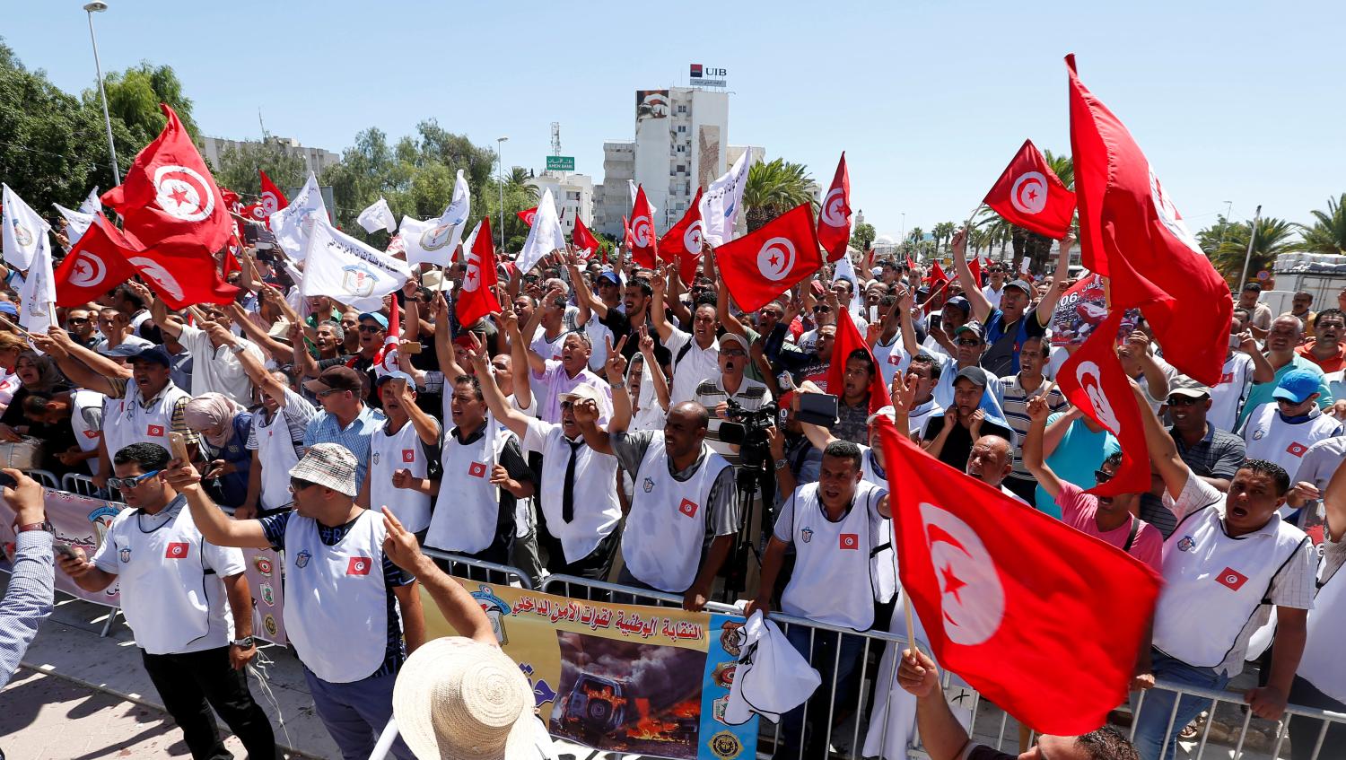 Tunisian police officers and security personnel hold flags and shout slogans during a protest in Tunis, Tunisia July 6,2017. REUTERS/Zoubeir Souissi