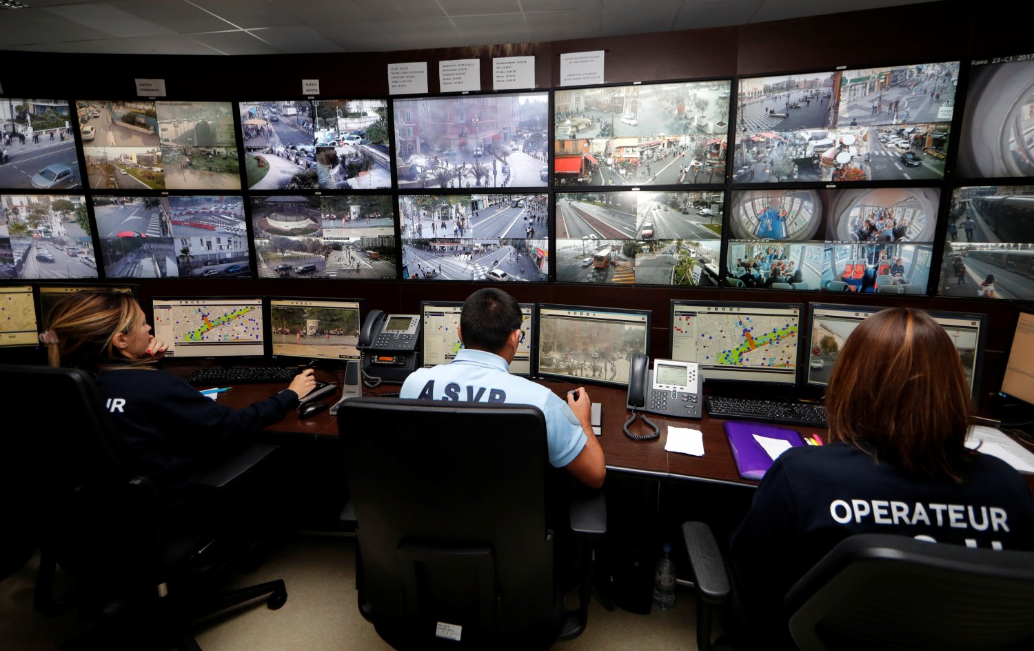 Municipal police officers watch screens in the video surveillance control room
