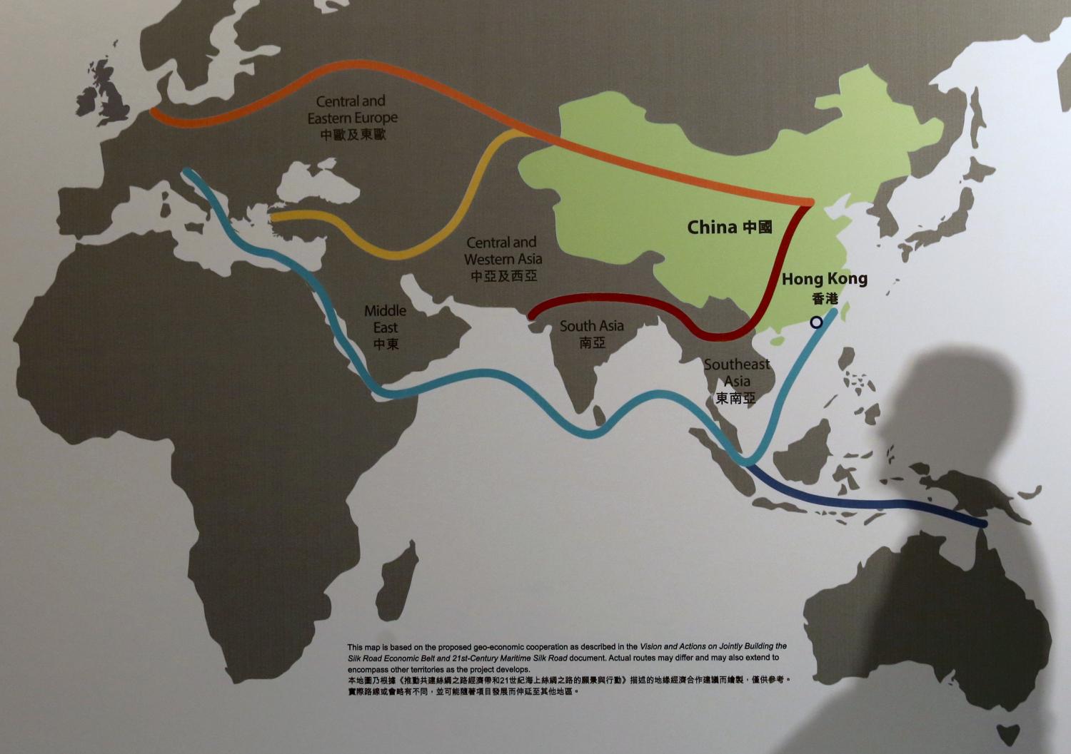 The shadow of a participant is seen on a map illustrating China's "One Belt, One Road" megaproject at the Asian Financial Forum in Hong Kong, China January 18, 2016. REUTERS/Bobby Yip - GF20000098473