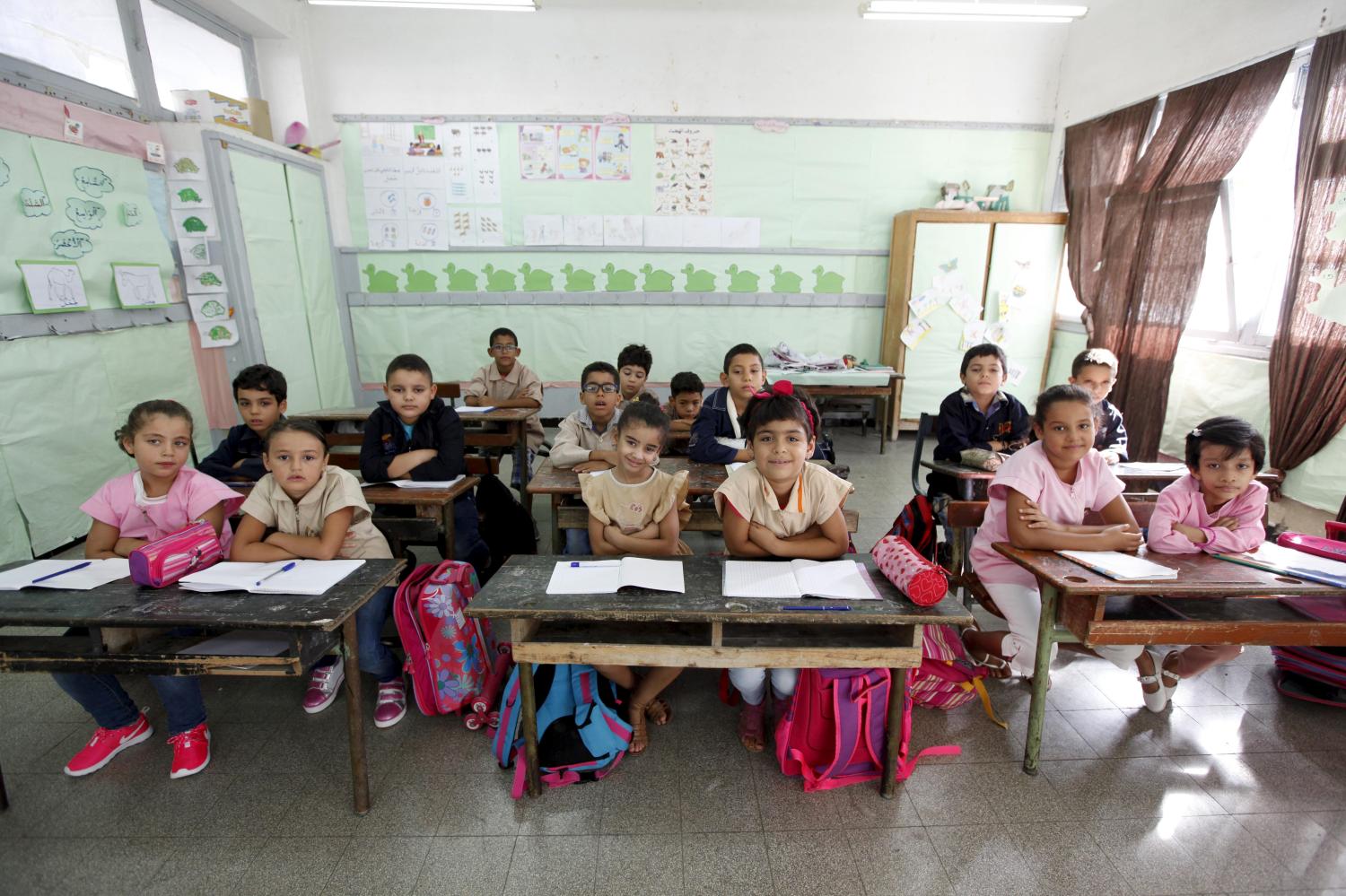 Students cross their arms to demonstrate they are listening carefully