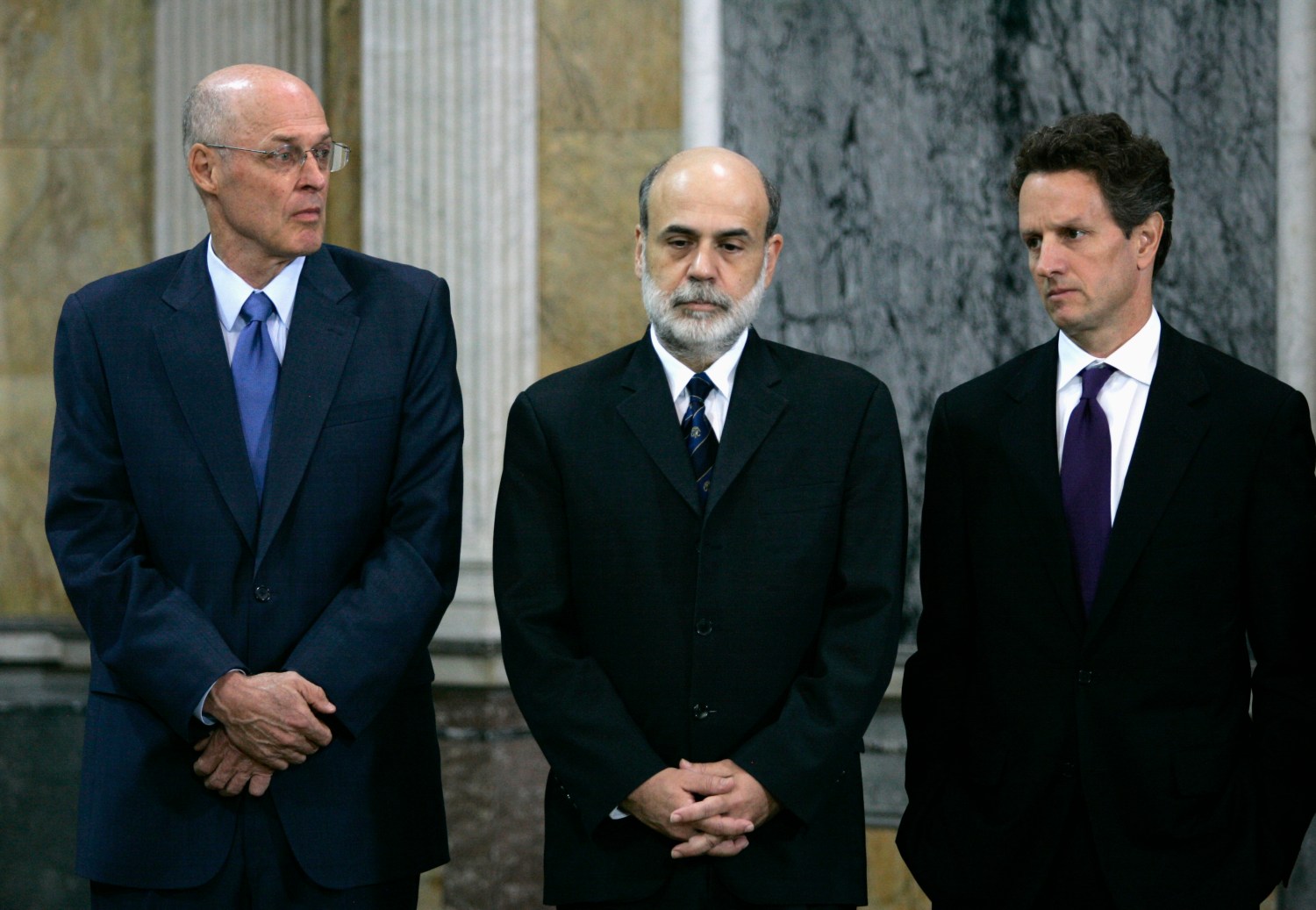 U.S. Treasury Secretary Henry Paulson (L), Federal Reserve Chairman Ben Bernanke (C) and President and CEO of the Federal Reserve Bank of New York Timothy F. Geithner listen as FDIC Chairman Sheila Bair (not pictured) speaks at the Treasury Department Cash Room in Washington.